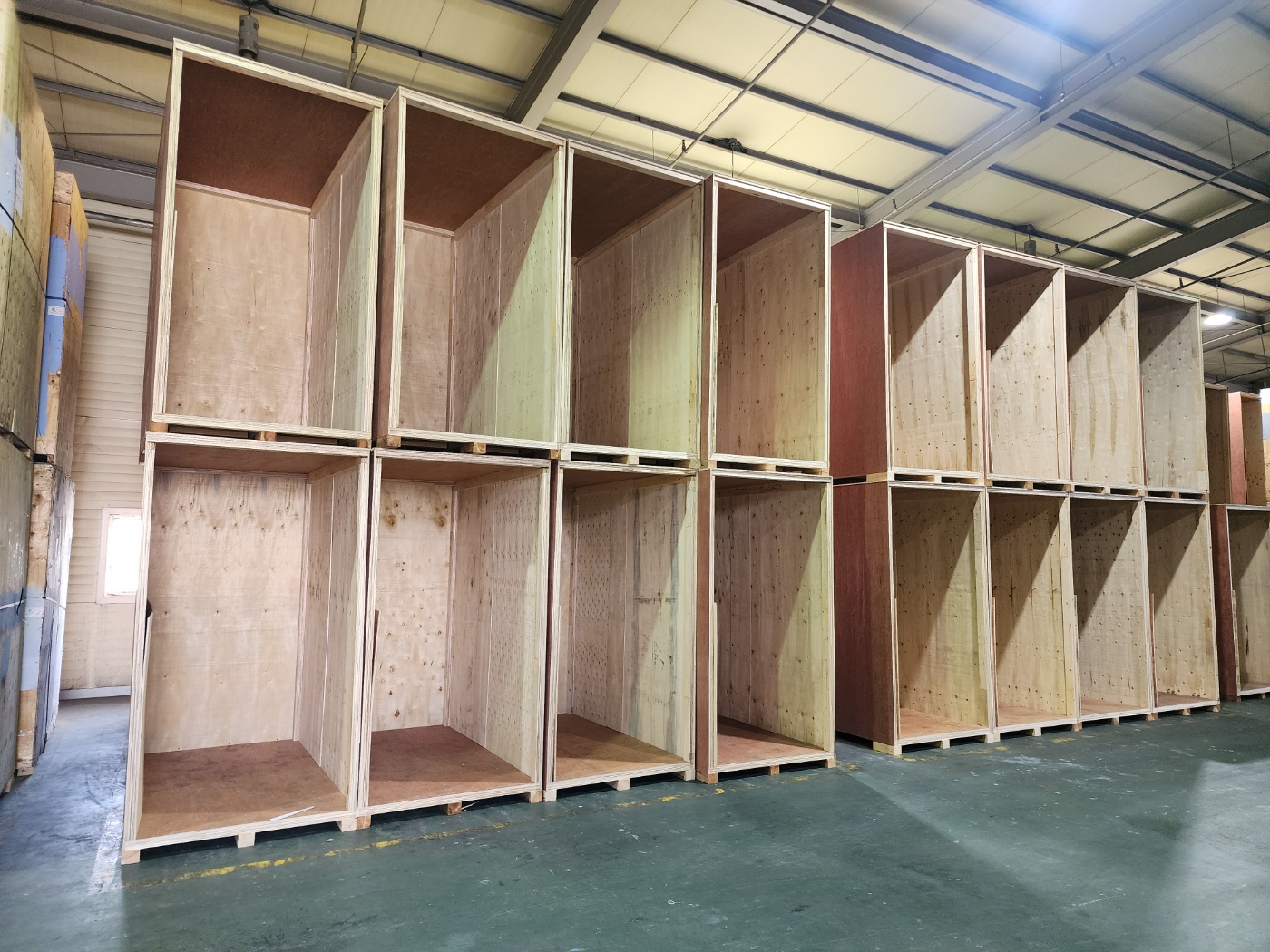 Rows of empty wooden storage crates inside JD PLANET’s warehouse